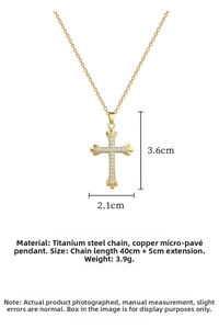 Detailed macro view of a gold cross pendant set with white zircon and a titanium steel chain