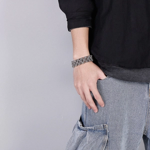 Detail shot of vintage silver men's thick chain bracelet with floral cross engravings