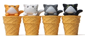 Detailed view of four cute cartoon cat figurines sitting in waffle ice cream cones