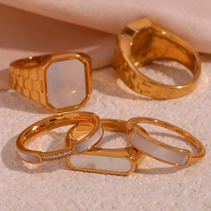 Set of five gold plated titanium rings with white mother of pearl and zircon stones