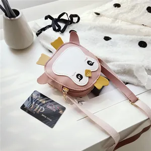 Detail view of pink PU leather penguin crossbody bag with adjustable shoulder strap