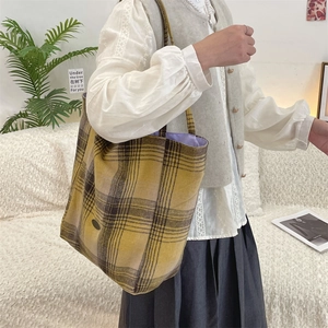 Close-up of a large vintage plaid tote bag with checkered pattern and purple lining