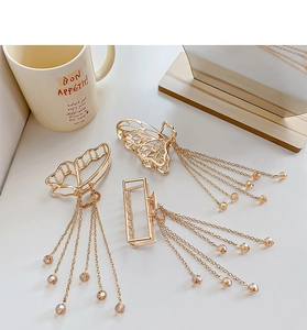 Three-piece gold butterfly hair clips set with metallic tassels and beaded fringe detail