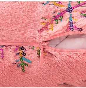 Detailed macro view of pink plush pillow cover with sequins and invisible zipper