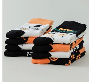 Detailed stack of knitted Halloween socks with pumpkin patterns and holiday text