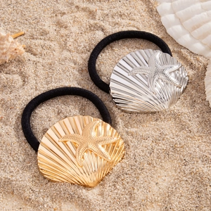 Detail of gold and silver shell and starfish charms on elastic ponytail holders