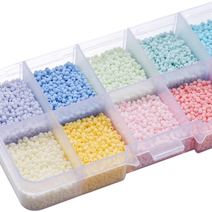 Macro view of macaron colored glass seed beads kit in transparent storage box