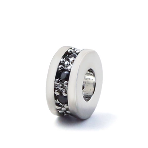 Macro detail of silver spacer bead with micro-paved black zircon stones for DIY jewelry