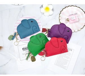 Flat lay of colorful elephant leather coin purses with litchi grain and metal zippers