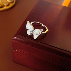 Elegant silver butterfly ring with crystal zircon wings on a red jewelry box