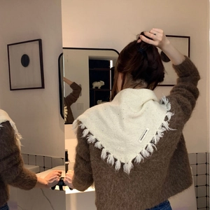 Cream white knitted triangle scarf with colorful speckles and tassels on model back view