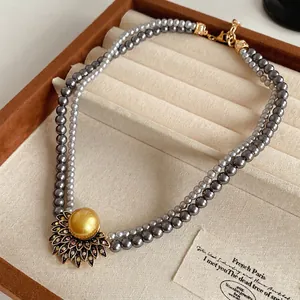 Vintage double layer grey pearl necklace with a sunflower pendant and golden center pearl