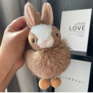 Close-up of a fluffy dark brown bunny plush keychain with real fox fur texture and long ears