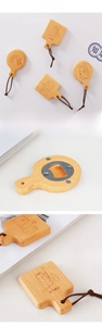 Detail of wooden magnetic beer bottle openers featuring round and rectangular shapes