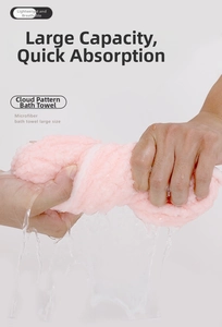 Pink cloud-pattern microfiber bath towel showing fast water absorption when wrung out