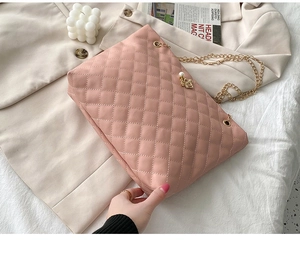 Pink quilted chain crossbody bag with faux leather and elegant pearl pendant detail
