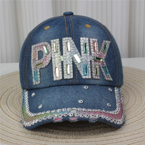 Detailed view of the sparkling pink rhinestone letters on this denim baseball cap