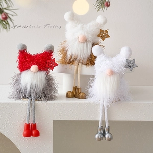 Three festive Christmas gnomes with long legs and star accessories on a white staircase