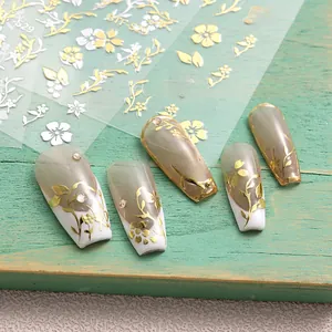 Detail of floral nail stickers with gold foil and white silk print patterns on nails