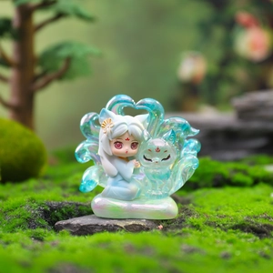 Mythical nine-tailed fox girl figurine with iridescent finish in a lush garden setting
