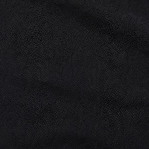 Dettaglio macro della trama in pizzo nero e dell'intreccio delle fibre della tutina sexy