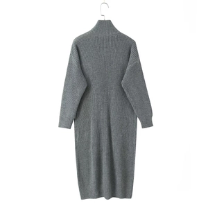 Detailed close-up of dark grey thick knit texture and ribbed pattern on long sweater dress