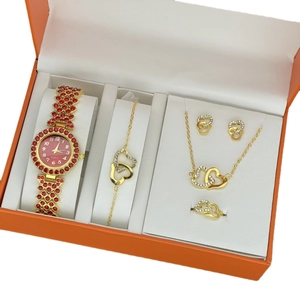 Golden watch and jewelry gift set with red heart crystals in an orange display box
