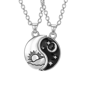 Tai Chi Yin Yang necklaces with sun and moon celestial engraving on white background
