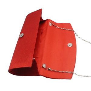 Detailed interior of red satin evening clutch with silver magnetic snaps and chain