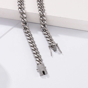 Detailed close-up of a silver Cuban link chain featuring a diamond-encrusted box clasp