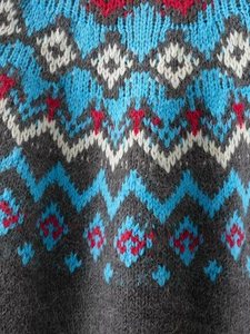 Detailed macro view of Jacquard knit sweater texture with warm wool blend fibers