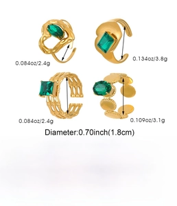 Detail showing set of four gold stainless steel rings with green stones and heart motifs