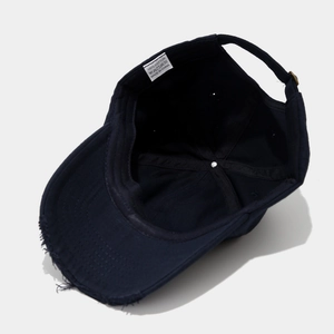 Detail view of cotton baseball cap interior featuring neat stitching and wash label
