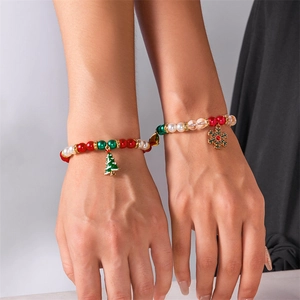 Detail of Christmas magnetic couple bracelets with festive beads and charms