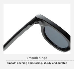 Detailed close-up of durable metal hinges on vintage oval black sunglasses