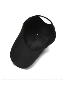 Internal view of black cotton baseball cap showing stitching and 100% cotton tag