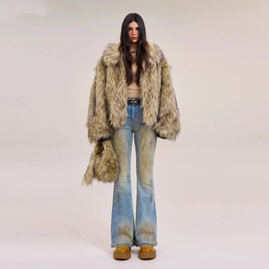 Faux fur coat with distressed flare jeans and platform boots in a full studio shot