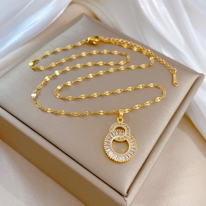 Elegant gold double loop figure-8 necklace with zircon inlay on a silk background