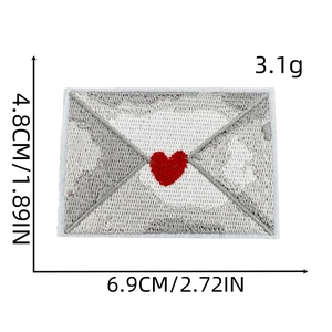 Detail showing embroidered heart envelope patch with precise dimensions 6.9cm by 4.8cm