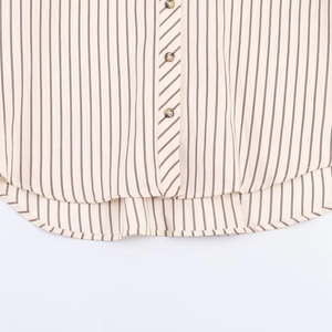 Mens casual striped shirt with vertical brown stripes and amber buttons on beige fabric