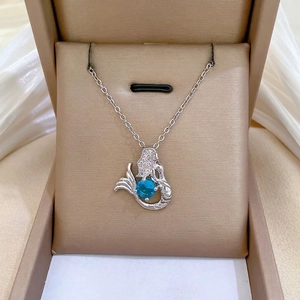 Elegant mermaid necklace with blue gemstone and diamonds in a luxury jewelry box