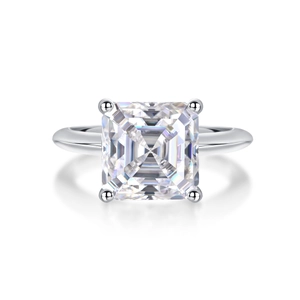 Square cut princess moissanite ring with four-prong silver band and elegant reflection