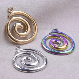 Detailed macro of spiral 18k gold, silver, and rainbow 304 stainless steel pendants