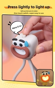 Macro detail of cartoon octopus night light showing the top power button and warm glow