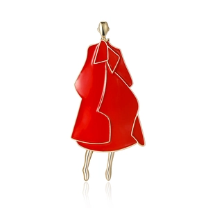 Fashionable enamel brooch featuring a woman in a red coat with gold metal outlines
