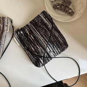 Close-up of the simple wish woven label and knit texture on the crossbody bag