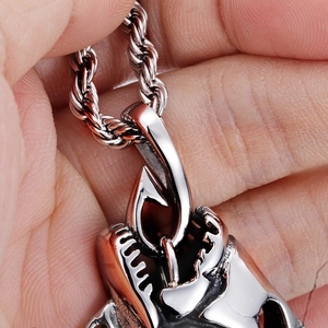Macro shot of silver fishbone pendant with twist chain showing intricate metal details