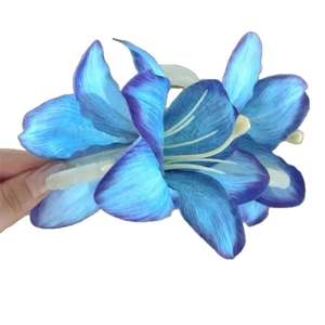 Blue lily flower hair clip with realistic petals and gradient finish on white background