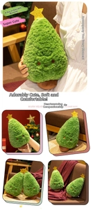 Detail of soft green plush Christmas tree with golden star and warm embroidered face