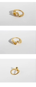 Macro view of minimalist wavy gold plated brass ring with irregular geometric texture